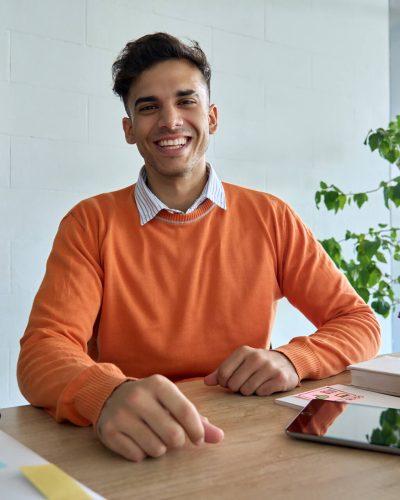 happy-smiling-indian-student-looking-at-camera-sit-2021-09-03-20-45-32-utc.jpg